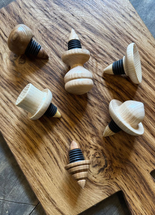 Wooden bottle stoppers with black rubber gaskets on wooden board