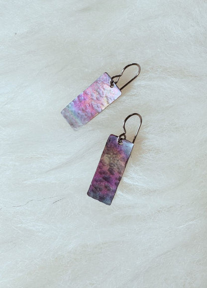 Pair of earrings with multi colour design on a white background